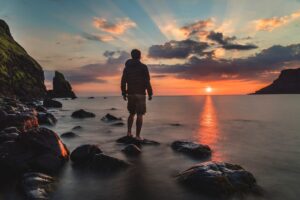 Man looking at a sunset - business planning