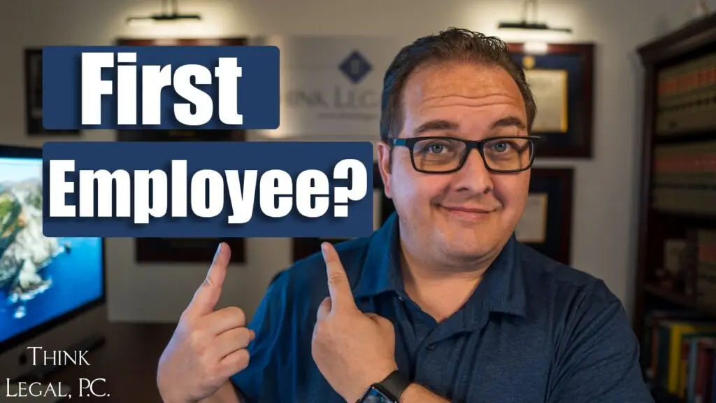 man_pointing_at_sign_first_employee